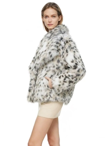 Detail of faux fur coat with snow leopard print featuring wide lapel and thick texture