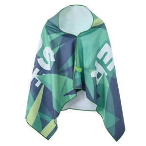 Detail of hooded quick-dry beach towel featuring green geometric leaf patterns and snap buttons