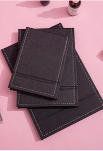 Detail showing high-quality black textured mats with contrast white stitching on a pink surface