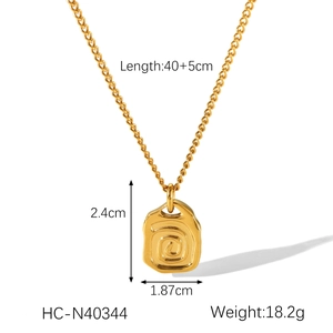 Detail view of gold abstract square swirl necklace with dimensions 2.4x1.87cm and specs