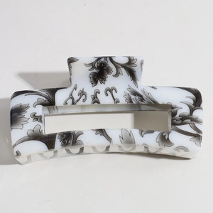 Detail view of the floral ink pattern on a rectangular white resin hair claw clip