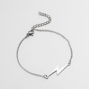 Detail showing the lightning bolt pendant and adjustable lobster clasp on silver chain