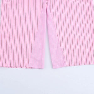 Detail shot of pink striped trousers featuring side slit hem and soft cotton fabric