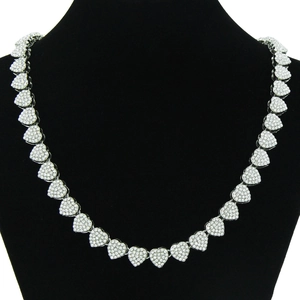 Detail of silver heart-shaped Cuban chain links encrusted with sparkling clear rhinestones