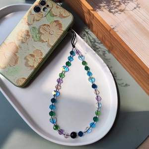 Detailed view of colorful crystal beaded phone strap with blue and purple heart beads