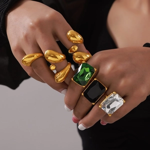 Chunky gold-plated geometric rings set with large emerald and crystal rectangle stones