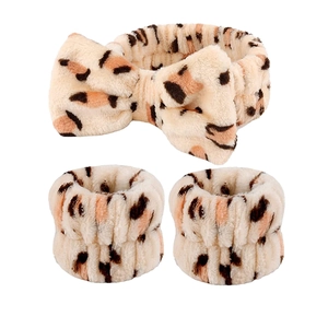 Leopard print plush headband and wristband set with a decorative bow accent