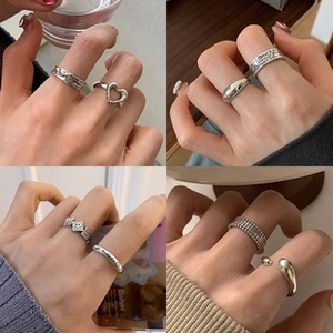 Detailed view of eight vintage silver-finished rings with various textured patterns