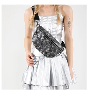 Detail of dark gray skull pattern waist bag featuring decorative metal chain and zipper