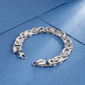 Detailed close-up of a silver stainless steel punk style bracelet with horseshoe chain links