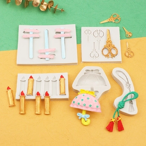 Detail of 5 DIY silicone molds for fondant showing umbrella, scissors, and candle shapes