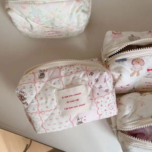 Detail of quilted cotton cosmetic bags with cute floral patterns and zip closure