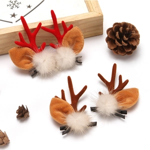 Plush Christmas reindeer antler hair clips with white fur balls on white background
