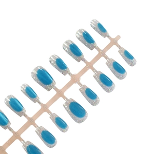 Short press-on nails with blue and silver gradient glitter and sapphire cat eye effect