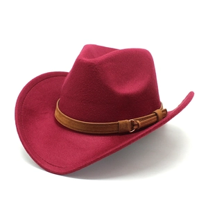 Detail of dark red felt cowboy hat with brown suede strap and golden buckle