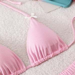 Detail of pink gingham bikini top with sweet bow accents and ruched triangle cups