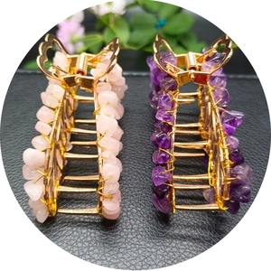 Golden butterfly hair clips with pink and purple natural crystal stones on black leather