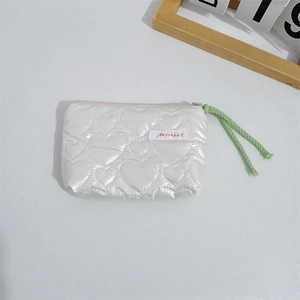 Detailed close-up of quilted heart pattern and Mayrabbit label on white PU mini pouch