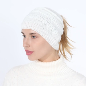 Detail of white knit ponytail beanie showing thick rib texture and back opening design