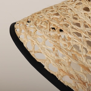 Close-up of raffia lolita hat with natural woven texture and black ribbon edge detail