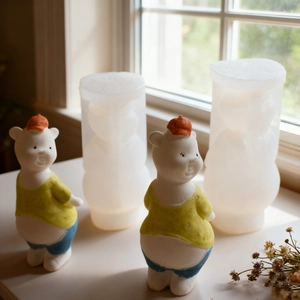 Detail shot of silicone molds and finished DIY hand-painted bear figurines by a window