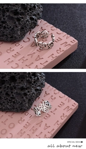 Detailed macro view of S925 sterling silver ring showing hollow heart pattern and 925 stamp