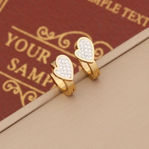 Elegant gold heart earrings with full diamond pavé inlay on a luxury jewelry box