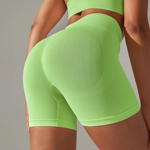 Close-up of high-waisted neon green seamless yoga shorts with scrunch butt lift detail