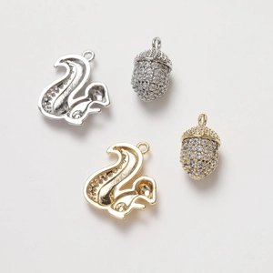 Detail of 14K gold plated squirrel and acorn pendants with sparkling zircon stones