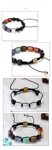 Macro detail of handmade woven bracelet with lava stones and natural crystal beads