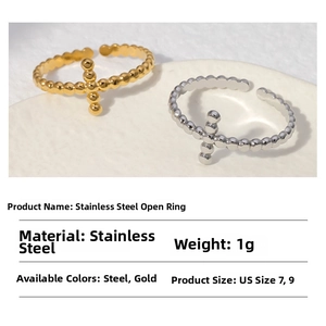 Macro shot of stainless steel beaded open rings in gold and silver finish with cross design