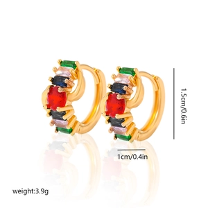 Macro detail of gold-plated hoop earrings with multi-colored cubic zirconia and size marks