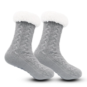 Detail view of gray cable knit slipper socks with soft white fleece trim and anti-slip sole