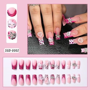 Close-up of pink press-on nails with 3D cartoon kitty, pearls and glitter stars detail