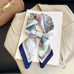 Detail of silk-like square scarf with architectural prints and navy blue contrast borders