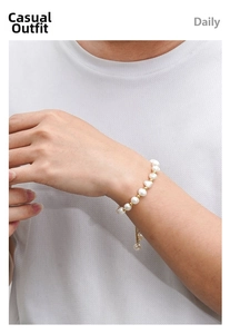 Detailed shot of irregular freshwater baroque pearl bracelet with gold spacer beads on wrist
