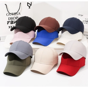 Multi-color collection of solid cotton baseball caps displayed on a minimalist white shelf