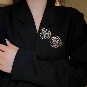 Silver rose flower brooch with crystals on black blazer for an elegant luxury style