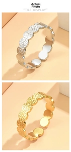 Detail of adjustable stainless steel flower rings with textured gold and silver finishes
