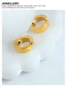 Detail view of 18k gold plated chunky hoop earrings on a decorative white tray