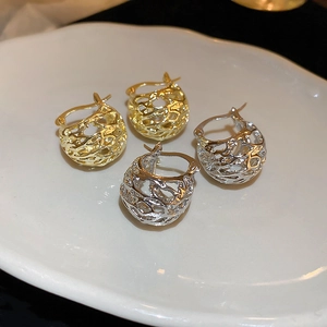 Modern hollow basket-style geometric hoop earrings in gold and silver finish