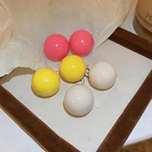 Three pairs of colorful candy round ball stud earrings in pink yellow and white resin