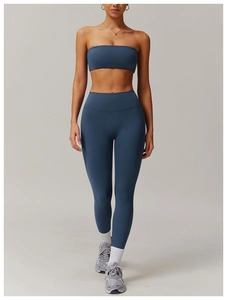 Close-up of slate blue high-waist yoga leggings and sports bra with seamless matte fabric