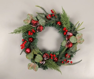 Detail of Christmas wreath with eucalyptus, red berries, and checkered bow decoration