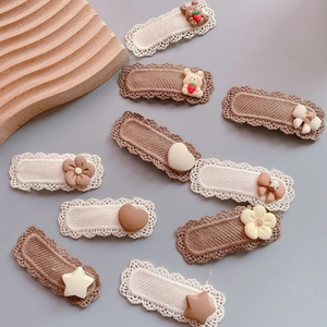 Close-up of cute knitted flower and animal hair clips in neutral milk tea brown tones