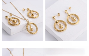 Detail of gold-plated twisted hoop earrings and necklace with smooth teardrop pendants