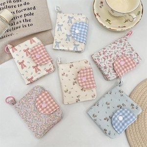 Close-up of floral fabric coin purses with snap buttons and metal keychain clips