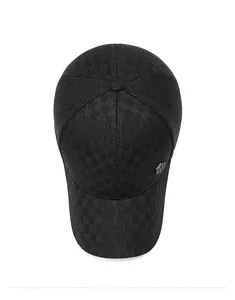 Top down view of black plaid baseball cap with hexagonal metal emblem and warm fleece lining