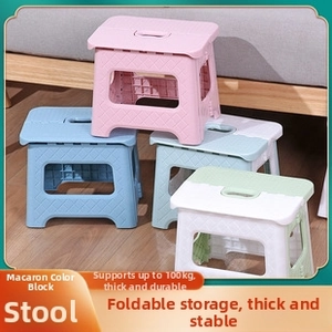 Macro detail of macaron colored folding stools with non-slip texture and handle