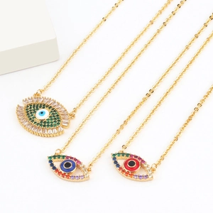 Three 18k gold necklaces with colorful evil eye heart pendants on white background